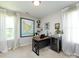 Bright office space featuring a desk, chair, wall art, mini fridge, and large windows at 4012 Martele Dr, Mint Hill, NC 28227