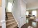Carpeted staircase leading to the upper level, with a view into the living area with a comfortable couch at 4012 Martele Dr, Mint Hill, NC 28227