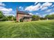 Inviting backyard featuring a screened porch and lush green lawn, perfect for outdoor relaxation and entertainment at 4047 Rainbow Hills Dr, Hickory, NC 28602