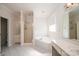 Bright bathroom with a glass enclosed shower, soaking tub and vanity with white cabinets at 4047 Rainbow Hills Dr, Hickory, NC 28602