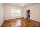 Bedroom featuring hardwood floors, a ceiling fan, and natural light from a large window at 4047 Rainbow Hills Dr, Hickory, NC 28602