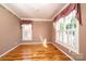 Light-filled bedroom featuring hardwood floors, neutral walls, and bright windows with classic trim at 4047 Rainbow Hills Dr, Hickory, NC 28602