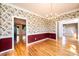 Traditional dining room boasts hardwood floors, chair railing, decorative wallpaper and views to additional rooms at 4047 Rainbow Hills Dr, Hickory, NC 28602