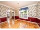 Traditional dining room boasts hardwood floors, chair railing, decorative wallpaper and natural light from a large window at 4047 Rainbow Hills Dr, Hickory, NC 28602