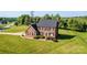 Charming two-story red brick home boasts a classic design with a well-manicured lawn and mature landscaping at 4047 Rainbow Hills Dr, Hickory, NC 28602