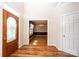 Elegant foyer featuring gleaming hardwood floors and a decorative front door with an adjacent dining room at 4047 Rainbow Hills Dr, Hickory, NC 28602