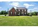Charming two-story brick home with black shutters and verdant lawn, exuding classic elegance and curb appeal at 4047 Rainbow Hills Dr, Hickory, NC 28602