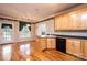 Kitchen with hardwood floors, black appliances, breakfast bar, and adjacent dining area at 4047 Rainbow Hills Dr, Hickory, NC 28602