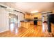Kitchen featuring hardwood floors, wooden cabinetry, and view to living room at 4047 Rainbow Hills Dr, Hickory, NC 28602