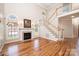 Open-concept living room with hardwood floors, fireplace, and staircase at 4047 Rainbow Hills Dr, Hickory, NC 28602