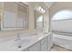 Bright bathroom with double sink vanity, white cabinetry, and large window at 502 Fly Fisher Dr, Salisbury, NC 28147