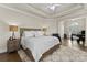 Serene bedroom with tray ceilings, a king-size bed, and a dedicated office space at 502 Fly Fisher Dr, Salisbury, NC 28147