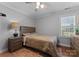 Cozy bedroom with neutral tones, wood furniture, and ample natural light at 502 Fly Fisher Dr, Salisbury, NC 28147