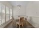 Bright dining area featuring hardwood floors, plantation shutters, and a modern chandelier at 502 Fly Fisher Dr, Salisbury, NC 28147