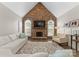 Cozy living room featuring a stone fireplace, vaulted ceiling, and plantation shutters at 502 Fly Fisher Dr, Salisbury, NC 28147