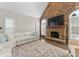 Inviting living room features a stone fireplace, large TV, and natural light from surrounding windows at 502 Fly Fisher Dr, Salisbury, NC 28147