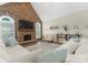 Comfortable living room with a stone fireplace, large TV, and decorative shelving at 502 Fly Fisher Dr, Salisbury, NC 28147