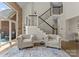Grand living room with a stone accent wall, staircase, and ample seating at 502 Fly Fisher Dr, Salisbury, NC 28147