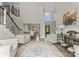 Spacious living room featuring soaring ceilings, a staircase, and view of the dining room at 502 Fly Fisher Dr, Salisbury, NC 28147