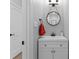 Modern powder room featuring sleek white cabinetry and a stylish round mirror at 502 Fly Fisher Dr, Salisbury, NC 28147