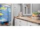 Bathroom with an oval sink, white cabinets, a unique shower curtain, and a decorative mirror at 5057 Sedgefield Dr, Lancaster, SC 29720