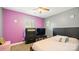 Bedroom featuring gray and purple walls, carpet flooring, a ceiling fan, and neutral bedding at 5057 Sedgefield Dr, Lancaster, SC 29720