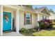 Close-up of the blue front door, surrounded by attractive landscaping and house number at 5057 Sedgefield Dr, Lancaster, SC 29720