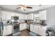 Well-lit kitchen with white cabinetry, stainless steel appliances, and wood-look flooring at 5057 Sedgefield Dr, Lancaster, SC 29720