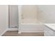 Bathroom showcasing tub, shower, and vinyl floor at 521 Ellingsworth Ln, Charlotte, NC 28214