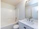 Well-lit bathroom with a shower and tub combo, a white vanity, and an updated faucet at 521 Ellingsworth Ln, Charlotte, NC 28214