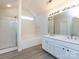 Bathroom featuring double sink vanity, shower and bathtub, and bright light fixtures at 521 Ellingsworth Ln, Charlotte, NC 28214