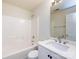 Bathroom featuring a white vanity, a toilet, a shower-tub combo, and a mirror with contemporary fixtures and neutral walls at 521 Ellingsworth Ln, Charlotte, NC 28214