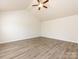Bedroom featuring vaulted ceiling and hardwood flooring, perfect for relaxation and comfort at 521 Ellingsworth Ln, Charlotte, NC 28214