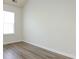 Well-lit bedroom with a window, wood-look floors, and neutral walls, creating a serene and inviting space at 521 Ellingsworth Ln, Charlotte, NC 28214