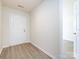 Bright entryway with white door, wood floors, and easy access to the rest of the home at 521 Ellingsworth Ln, Charlotte, NC 28214