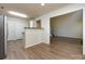 Spacious living room featuring open access to kitchen, multiple closets, and wood floors at 521 Ellingsworth Ln, Charlotte, NC 28214