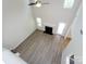 Top-down shot showcases living room's fireplace, high ceiling, and neutral flooring, with a view to the backyard at 521 Ellingsworth Ln, Charlotte, NC 28214