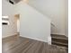 Open-concept living room with hardwood floors, a staircase, and natural light from large windows at 521 Ellingsworth Ln, Charlotte, NC 28214