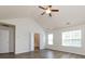 Spacious main bedroom featuring vaulted ceiling, wood-look floors, and an ensuite bathroom at 521 Ellingsworth Ln, Charlotte, NC 28214
