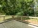 Wooden deck providing an inviting space for outdoor relaxation with a view of green trees and natural light at 521 Ellingsworth Ln, Charlotte, NC 28214