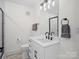 Modern bathroom with sleek vanity, updated fixtures, black framed shower, and contemporary finishes at 5219 Farmbrook Dr, Charlotte, NC 28210