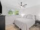 Inviting bedroom featuring hardwood floors, ceiling fan, natural light and comfortable queen-sized bed at 5219 Farmbrook Dr, Charlotte, NC 28210