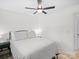 This is a cozy bedroom with a ceiling fan and striped bedding at 5219 Farmbrook Dr, Charlotte, NC 28210