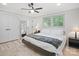 Bright bedroom boasts hardwood floors, a ceiling fan, a walk-in closet, and abundant natural light at 5219 Farmbrook Dr, Charlotte, NC 28210