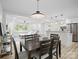Open-concept dining area flowing into the living room and kitchen, perfect for entertaining, with seating for six at 5219 Farmbrook Dr, Charlotte, NC 28210