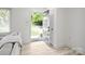 Bright entryway featuring a stylish door, light floors, and neutral walls, creating a welcoming transition space at 5219 Farmbrook Dr, Charlotte, NC 28210