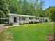 Inviting home featuring a well-maintained lawn, complemented by a convenient carport enhancing functionality and curb appeal at 5219 Farmbrook Dr, Charlotte, NC 28210