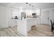 Modern kitchen featuring white cabinetry, stainless steel appliances, and an island with seating, perfect for cooking and gathering at 5219 Farmbrook Dr, Charlotte, NC 28210