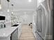 Bright, open kitchen featuring stainless steel appliances, quartz countertops, breakfast bar, and modern lighting at 5219 Farmbrook Dr, Charlotte, NC 28210