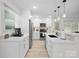 Stylish kitchen with white cabinets, stainless steel appliances, and modern lighting creating an inviting space for cooking and gathering at 5219 Farmbrook Dr, Charlotte, NC 28210